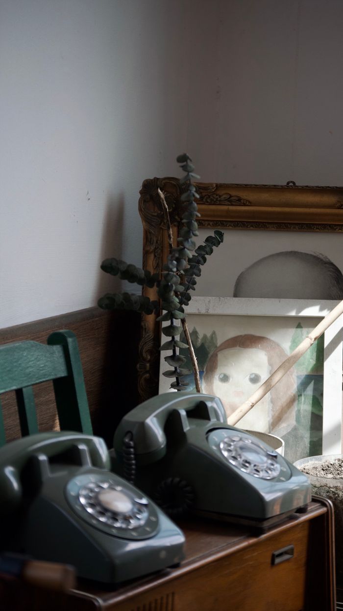 A nostalgic scene with retro phones and framed art capturing vintage vibes.